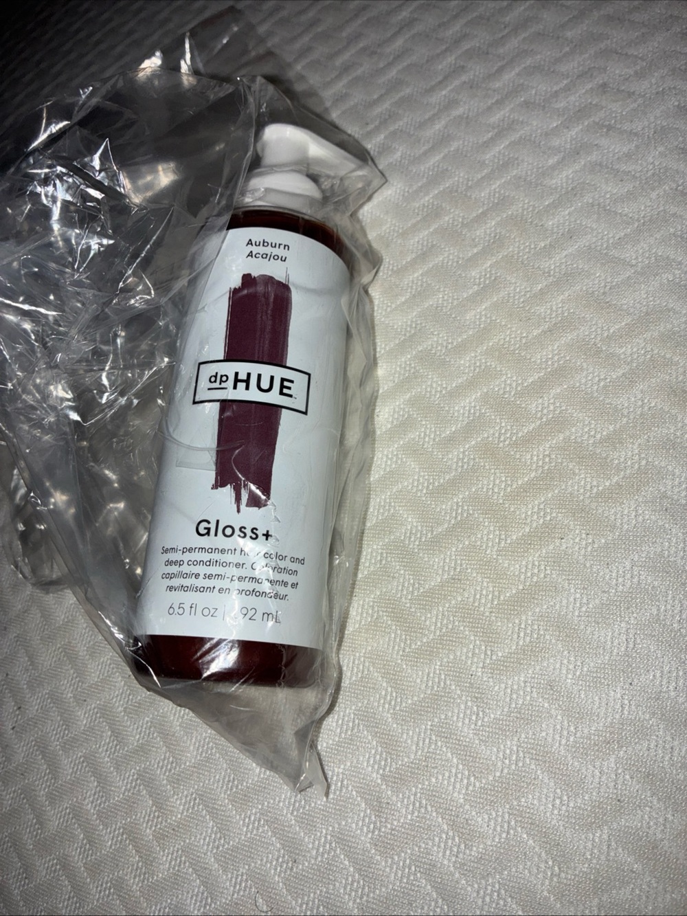 Hair gloss bottle on fabric